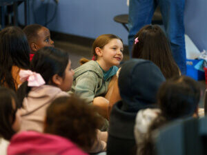 Students seated on the floor for instrucation.