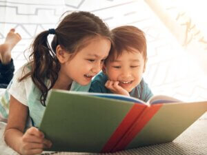 Two children reading from a book together